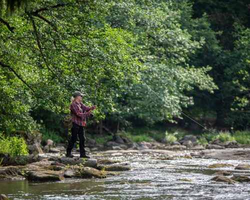 Woman,Fly,Fishing,On,The,River,In,Finland